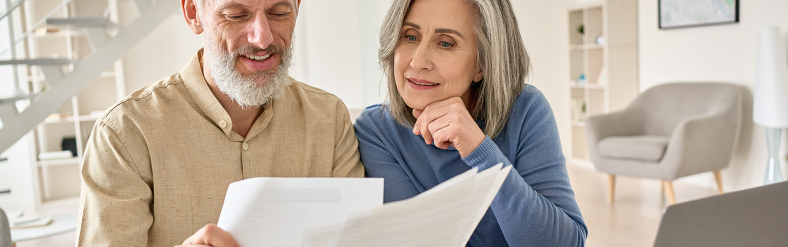 Mature couple reading documents together