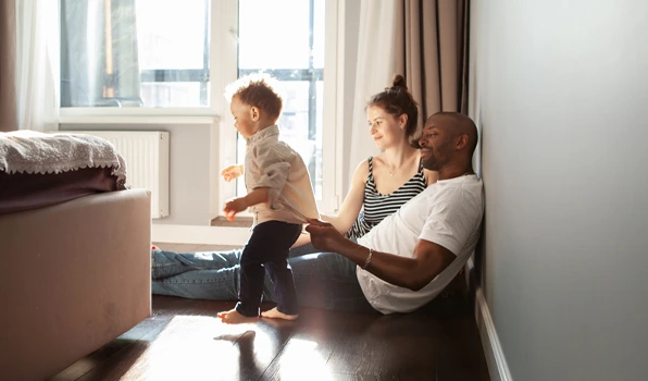 Family spending time together at home, illustrating the financial management tools and budgeting features available through a checking account to help manage everyday finances.