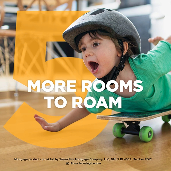 Young child wearing a helmet riding a skateboard indoors with the text &ldquo;More Rooms to Roam&rdquo;