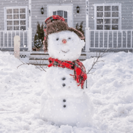 Happy snowman outside a gray home.